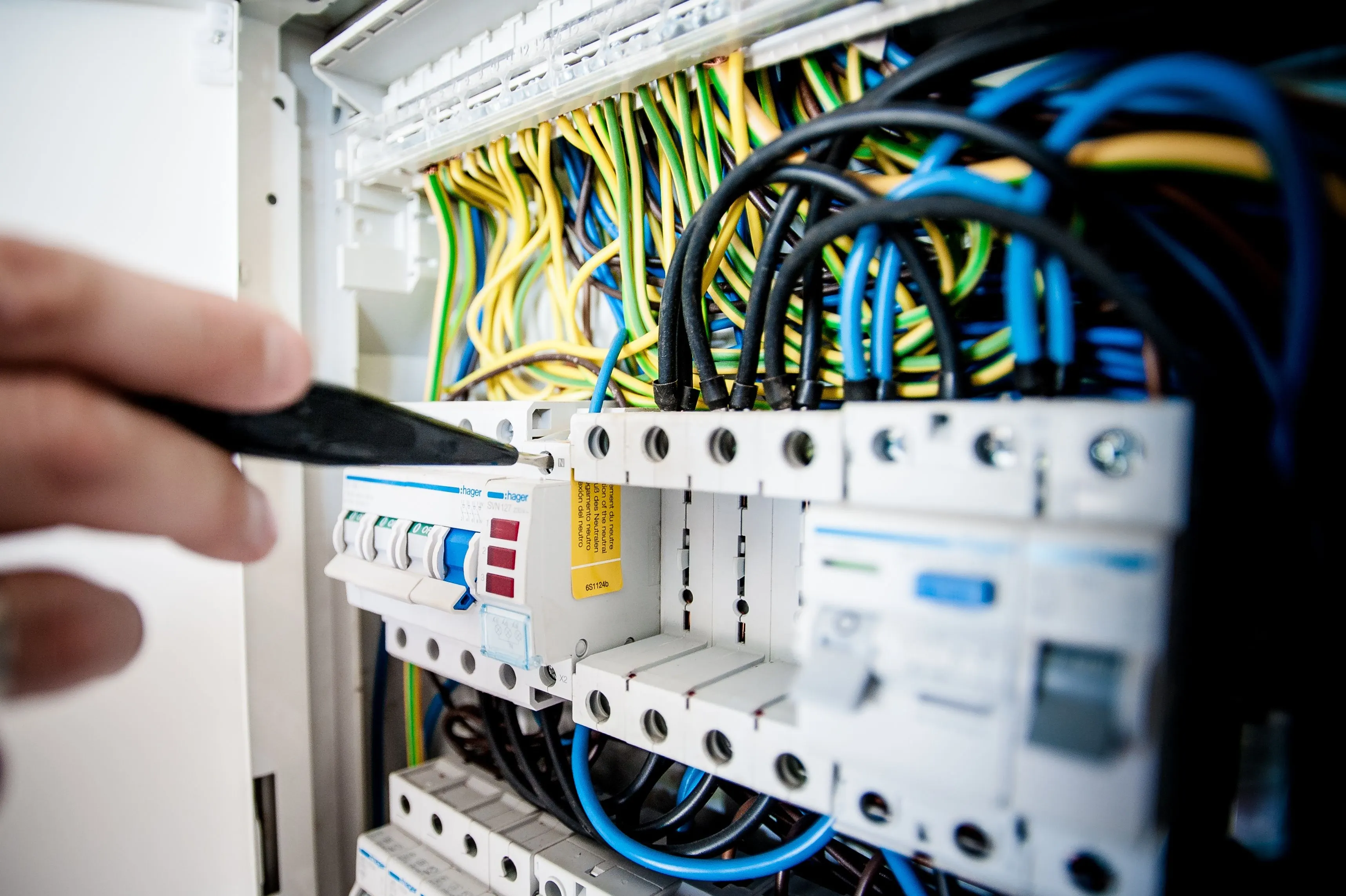 Electrician checking a consumer unit during an electrical safety inspection in Hastings and St Leonards-on-Sea